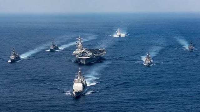 A group of military ships in the water

Description automatically generated with low confidence