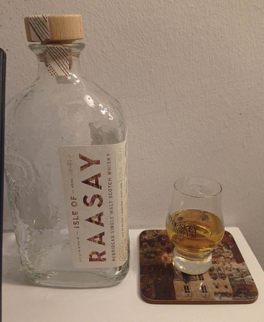 A bottle of alcohol next to a glass of liquid

AI-generated content may be incorrect.