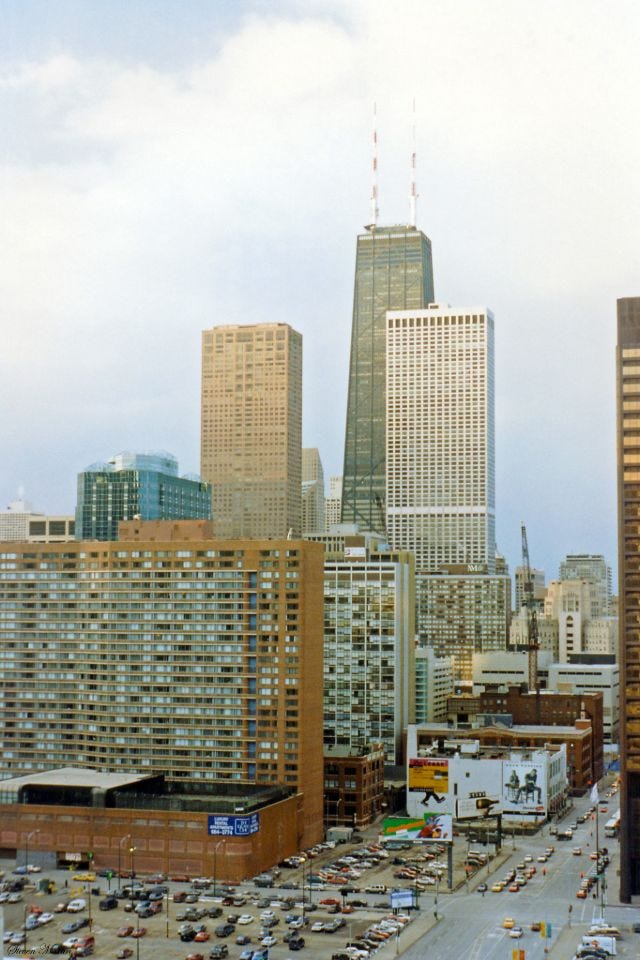 The distinctive John Hancock Center and Water Tower Place towering above the cityscape, seen from the Sheraton Hotel, Chicago, February 1996. The distinctive John Hancock Center and Water Tower Place towering above the cityscape, seen from the Sheraton Hotel, Chicago, February 1996.