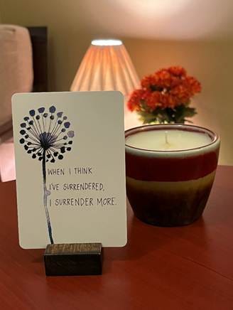 A candle and a card on a table

AI-generated content may be incorrect.