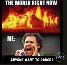 This may contain: a man talking on a cell phone in front of a burning building with the caption me anyone want to dance?