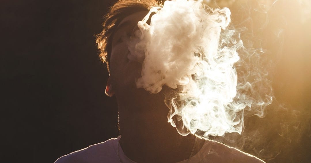 man in white shirt with white smoke concept photography