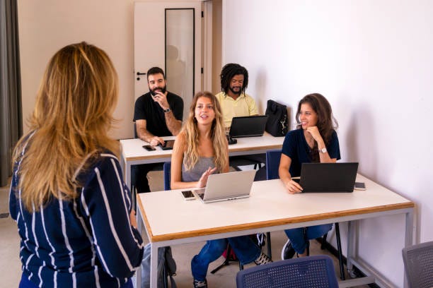 Group of students and a teacher in a classroom.
