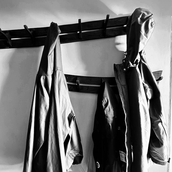 two images that both share the theme of five shades of grey on the left coats on a coat rail on the right toilet roll sitting on a shelf in a bathroom