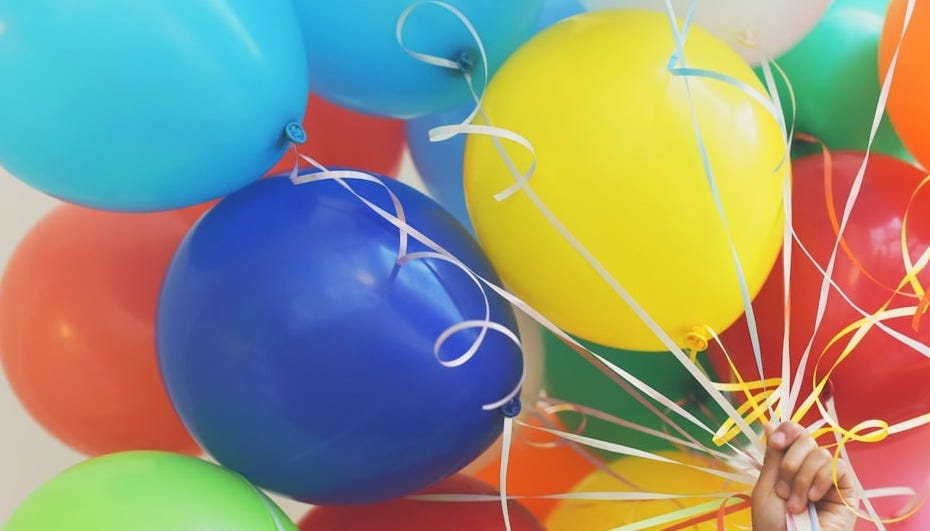 person holding balloons person holding balloons