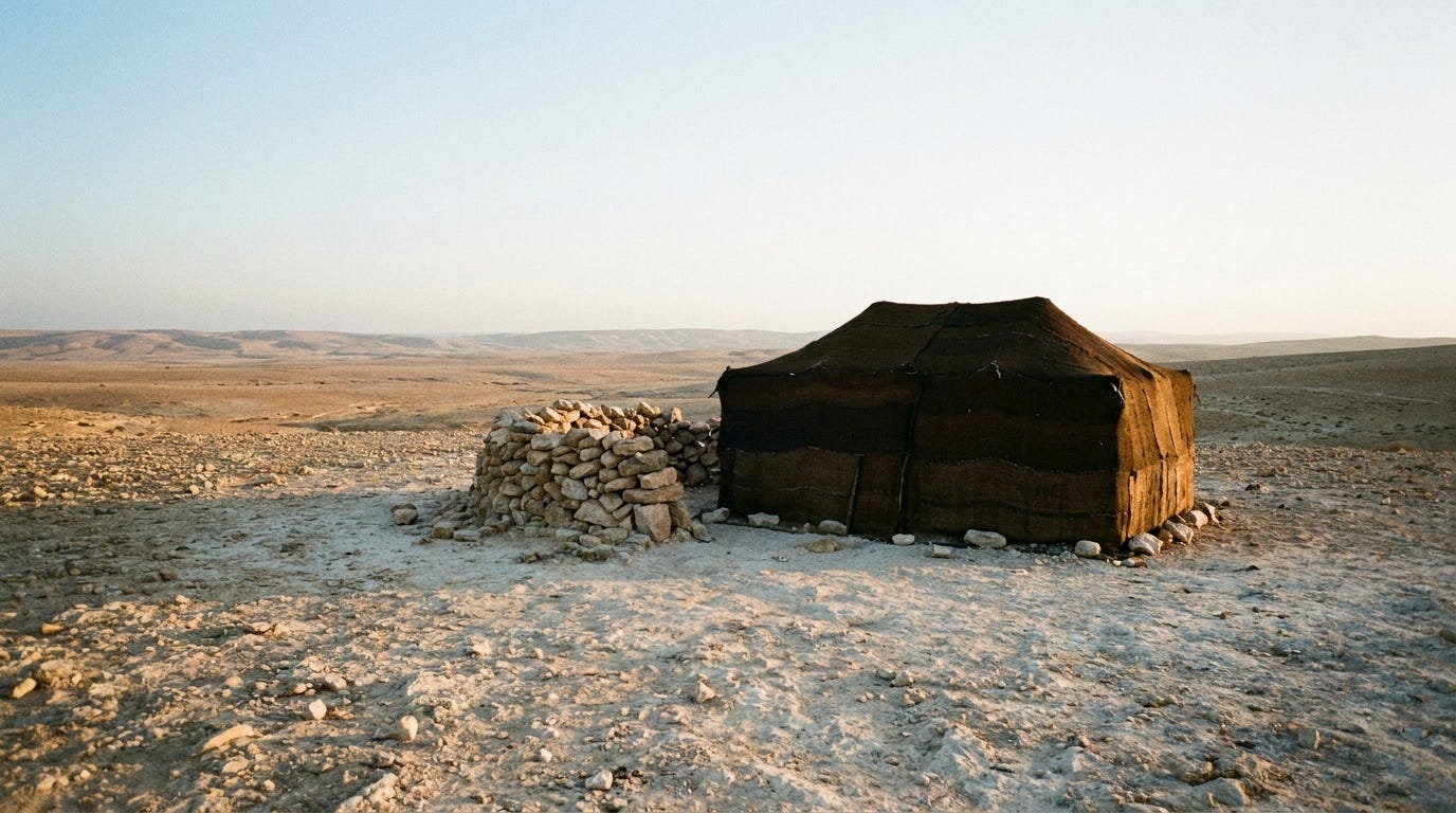 A low pile of rough stones and a single small goat-hair tent on dry pale highland at first light, cool dawn giving way to warm gold across the stony ground, a wide empty land opening north toward distant hills, unstaged documentary landscape, no people, no faces, no text, mid-tones and warm highlights A low pile of rough stones and a single small goat-hair tent on dry pale highland at first light, cool dawn giving way to warm gold across the stony ground, a wide empty land opening north toward distant hills, unstaged documentary landscape, no people, no faces, no text, mid-tones and warm highlights