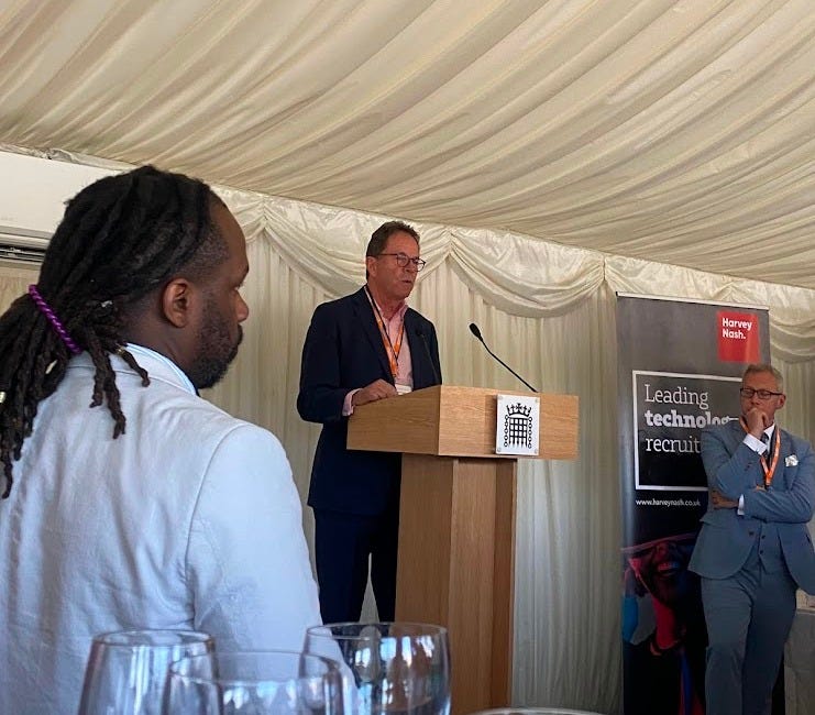 CIPD CEO Peter Cheese is talking to a room of people, in a tent-like room. 