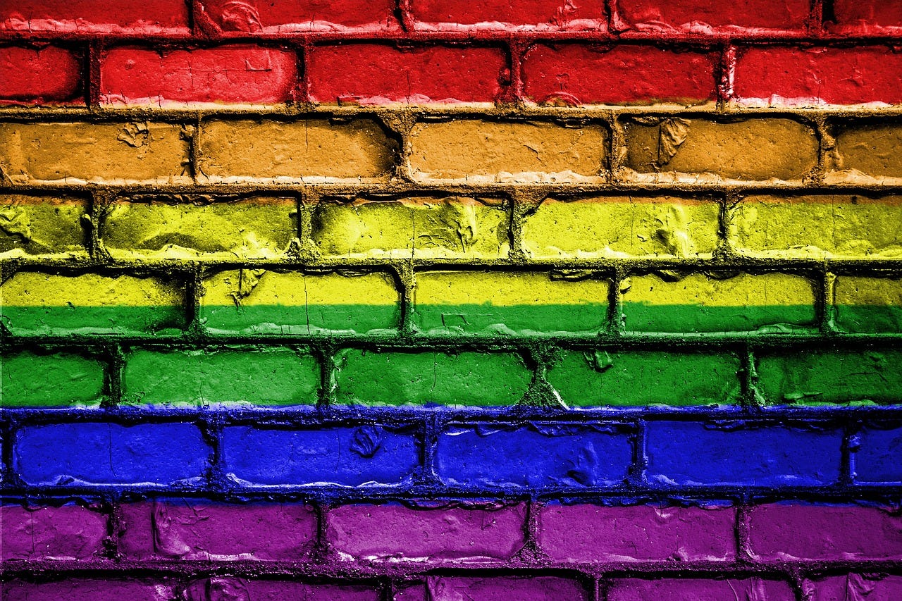 image of a brick wall that seemingly has the colors of the LGBTQ+ rainbow flag painted on it image of a brick wall that seemingly has the colors of the LGBTQ+ rainbow flag painted on it