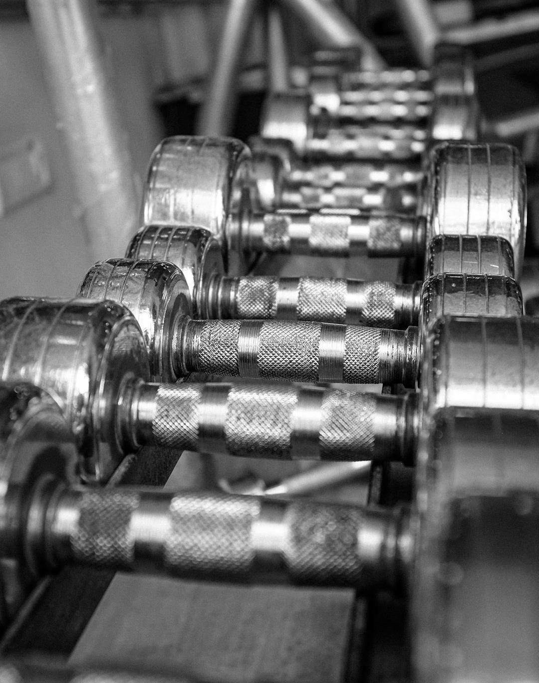 silver dumbbells on brown wooden table