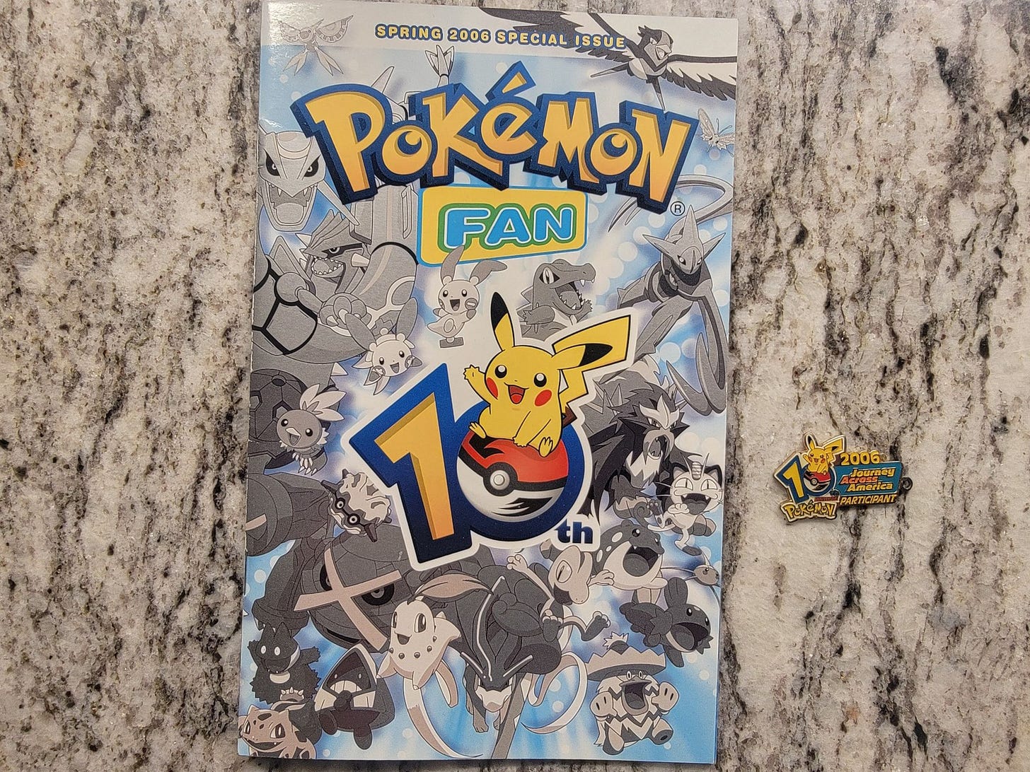 nza's Pokémon Journey Across America keychain from 2006, along with an issue of "Pokémon Fan" from Spring 2006 nza's Pokémon Journey Across America keychain from 2006, along with an issue of "Pokémon Fan" from Spring 2006