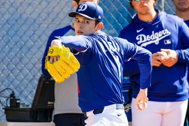 Roki Sasaki of the Los Angeles Dodgers pitches in the bullpen during workouts before a Spring Training game against the Athletics at Camelback Ranch...