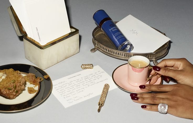 This may contain: a woman holding a pink coffee cup next to a plate with food and writing on it