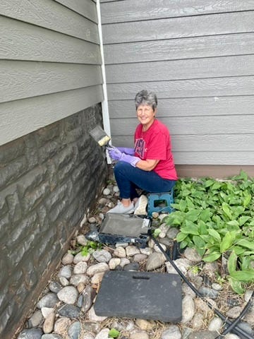Photos of the ladies painting outside the girls dorm.