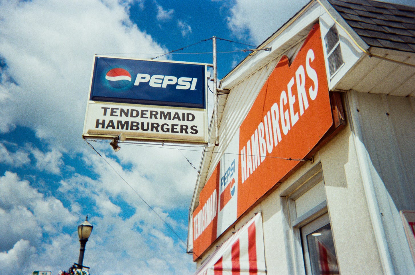 Vintage PEPSI sign with TENDERMAID HAMBURGERS written below