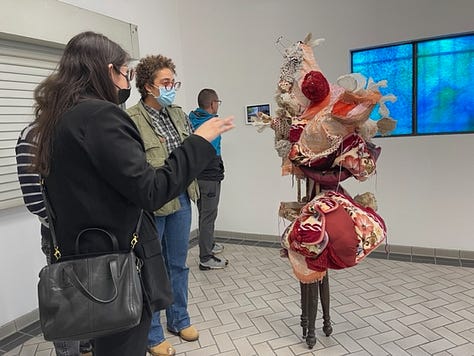 A grid of 9 photos. Four images are photos of the opening of Brenda Gonzalez's show, "Creature Comforts," at Arts at Blue Roof. Five images are photos of the installed sculptures and prints in the show.