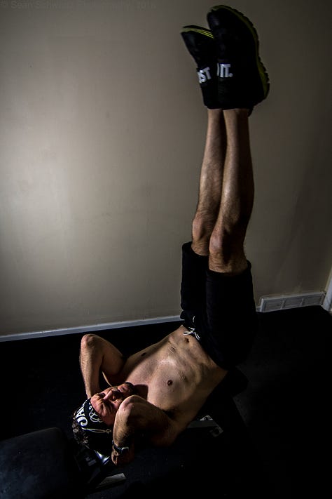 Handsome dude in gym/street clothes working out and posing like a fitness trainer guy