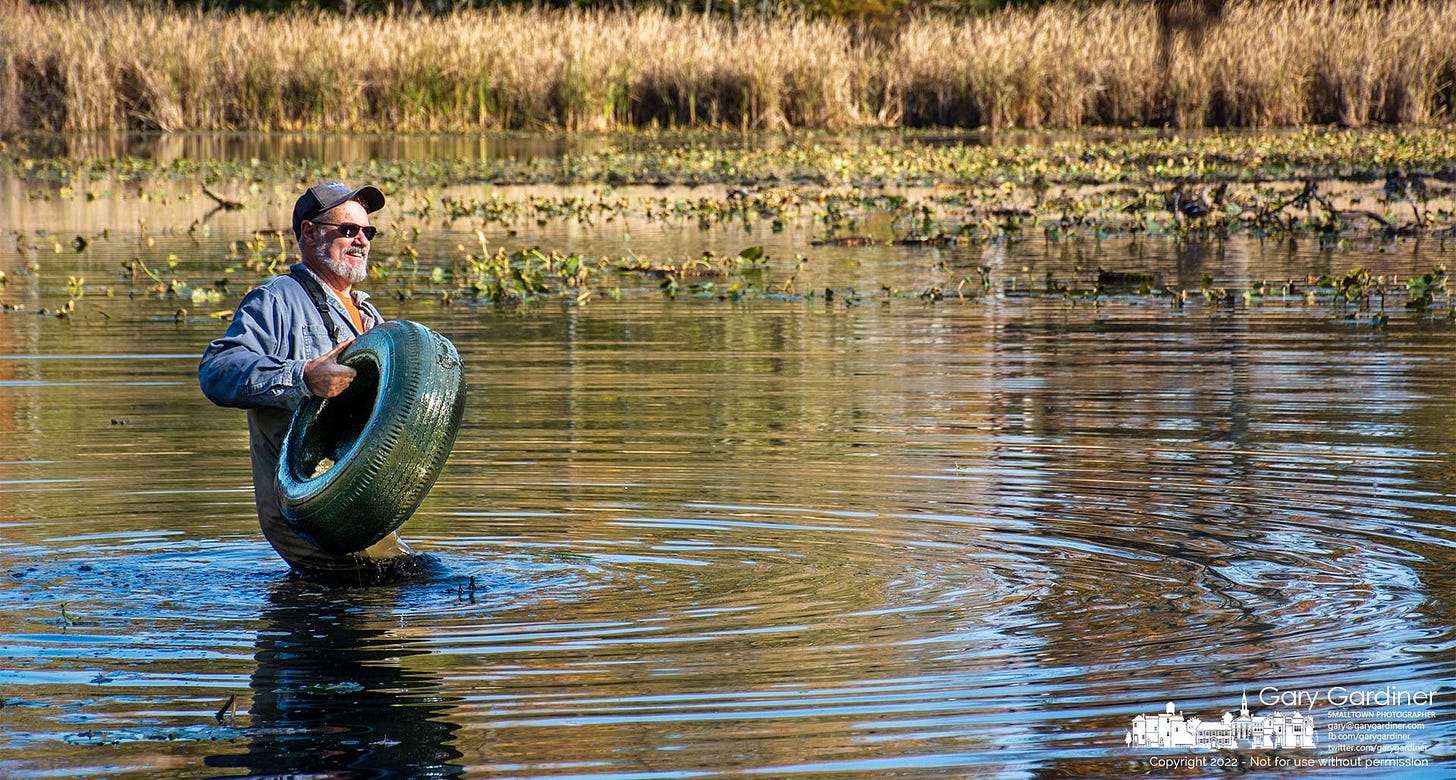 Mark Dilley removes a tire from the pond at Boyer Nature Preserve during Saturday's removal of invasive species, including tires, from the park, My Final Photo for October 22, 2022. Mark Dilley removes a tire from the pond at Boyer Nature Preserve during Saturday's removal of invasive species, including tires, from the park, My Final Photo for October 22, 2022.