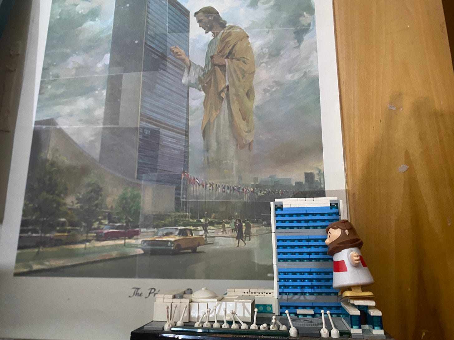 poster of Jesus next to 40 story building with Lego recreation below it