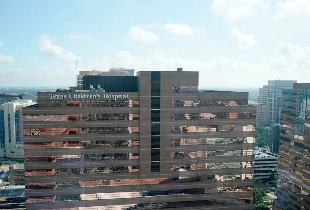 A large building with the words, “Texas Children’s Hospital” on the side.