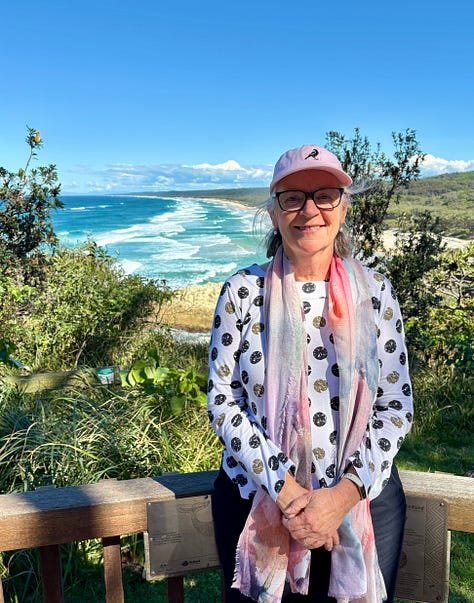 A woman in front of an ocean view, a kangaroo and a koala