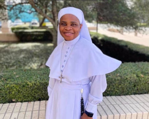 a woman in religious clothing smiles a woman in religious clothing smiles