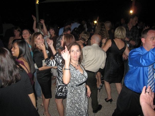 a woman on a crowded dance floor, looking like a very serious dancer