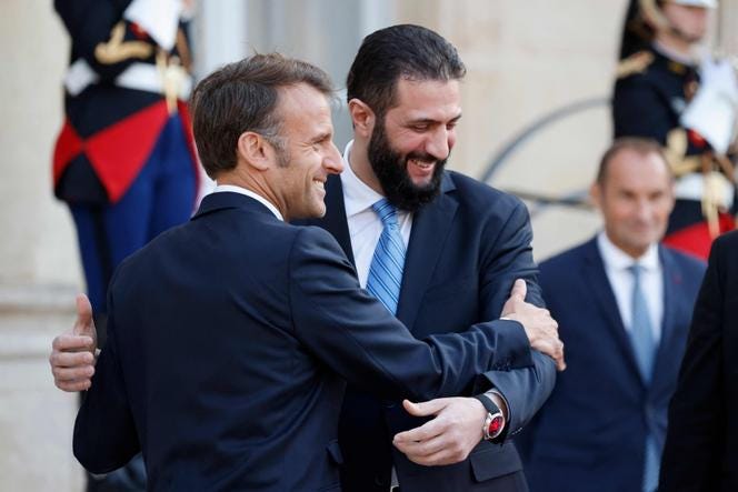 French President Emmanuel Macron and Syrian President Ahmed al-Sharaa greet each other after a joint press conference following a meeting at the Elysée Palace in Paris, on May 7, 2025.