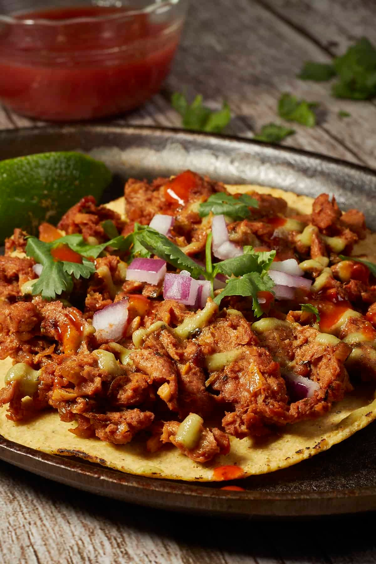 a corn tortilla topped with vegan carne asada