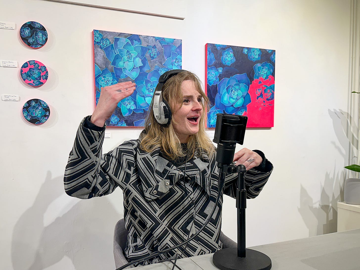 April Landry speaking into a microphone during podcast interview