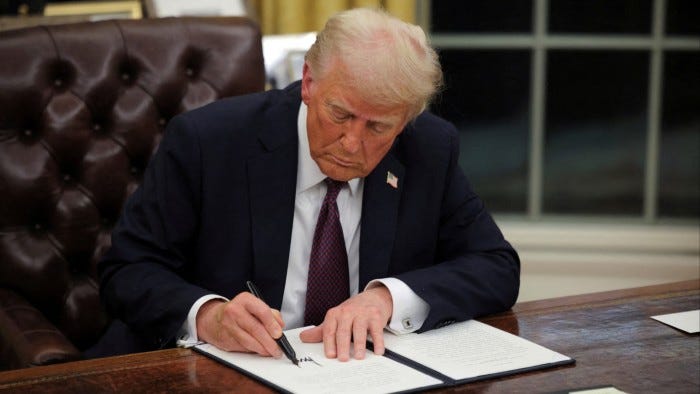 Donald Trump signing papers