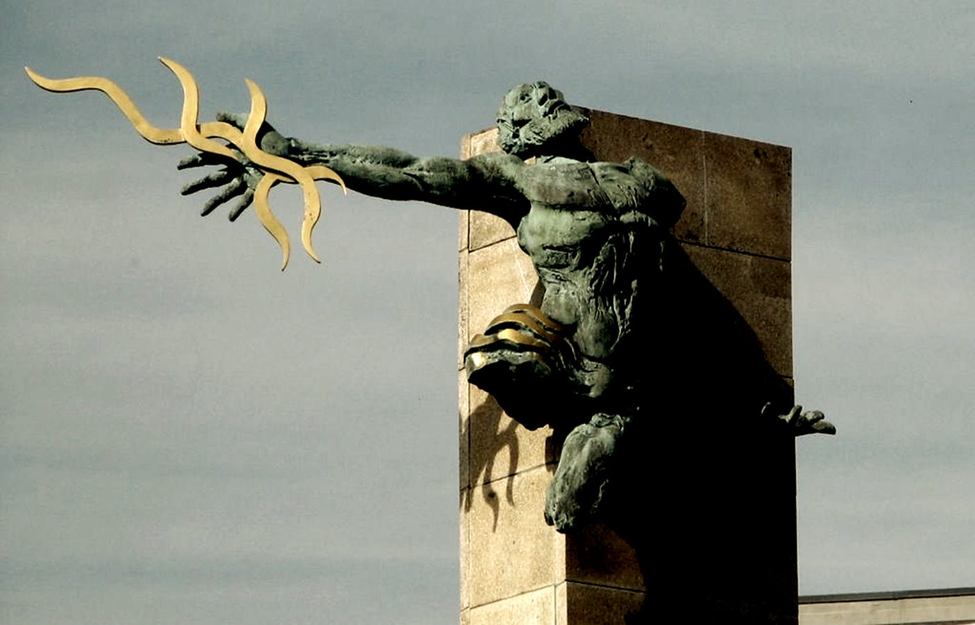 A statue of a person holding a gold object
AI-generated content may be incorrect.