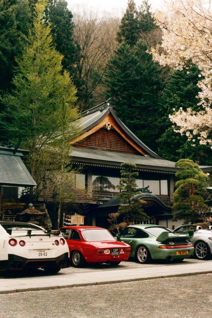 Cars lined up outside Suwa Taisha shrine, including a Nissan GT-R (left), 1967 Alfa Romeo Giulia 1300GT (centre) and a classic Porsche 911 (second from right)