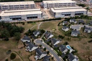 STONE RIDGE, VIRGINIA - JULY 17: In an aerial view, an Amazon Web Services data center is shown situated near single-family homes on July 17, 2024 in Stone Ridge, Virginia. Northern Virginia is the largest data center market in the world, according to a report this year cited in published accounts, but is facing headwinds from availability of land and electric power. (Photo by Nathan Howard/Getty Images) STONE RIDGE, VIRGINIA - JULY 17: In an aerial view, an Amazon Web Services data center is shown situated near single-family homes on July 17, 2024 in Stone Ridge, Virginia. Northern Virginia is the largest data center market in the world, according to a report this year cited in published accounts, but is facing headwinds from availability of land and electric power. (Photo by Nathan Howard/Getty Images)