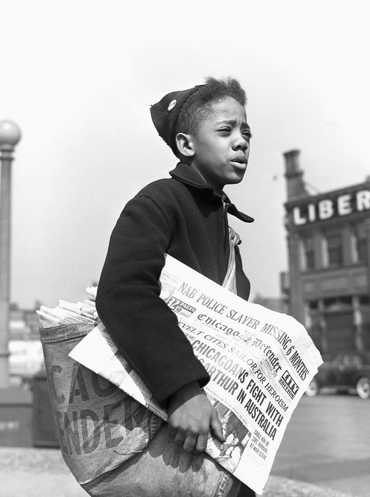 This may contain: an old black and white photo of a boy holding newspapers