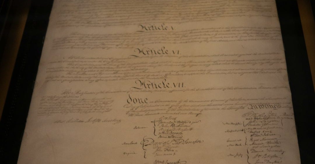 The u.s. constitution is framed and on display.