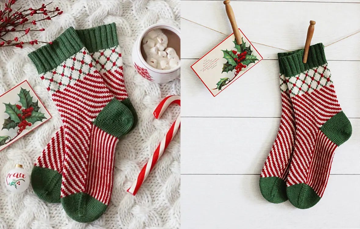 white, red and green colorwork socks on a white knitted blanket with christmas decorations