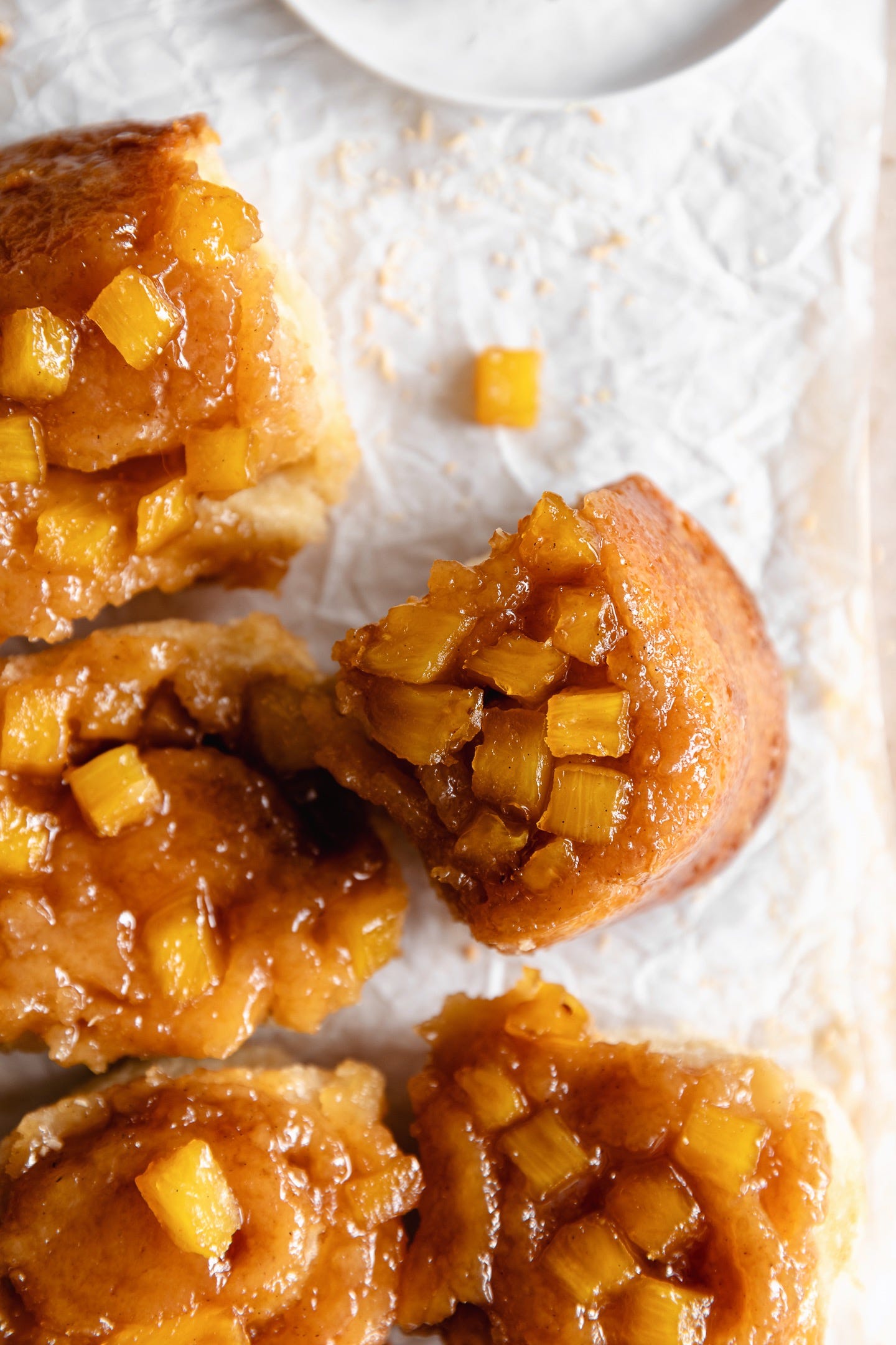 Vegan pineapple coconut sticky buns on parchment paper