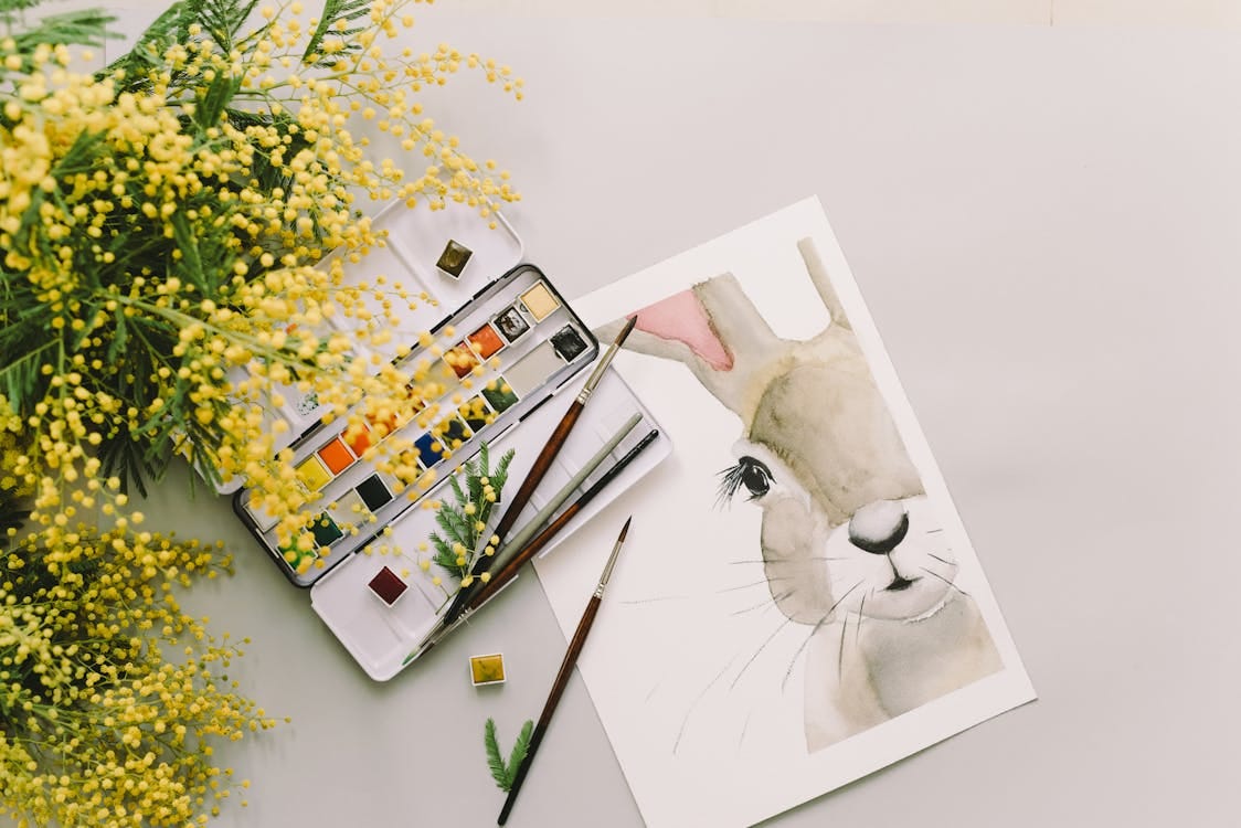 Free Artistic watercolor painting of a bunny with mimosa flowers, perfect for Easter or spring decor. Stock Photo Free Artistic watercolor painting of a bunny with mimosa flowers, perfect for Easter or spring decor. Stock Photo