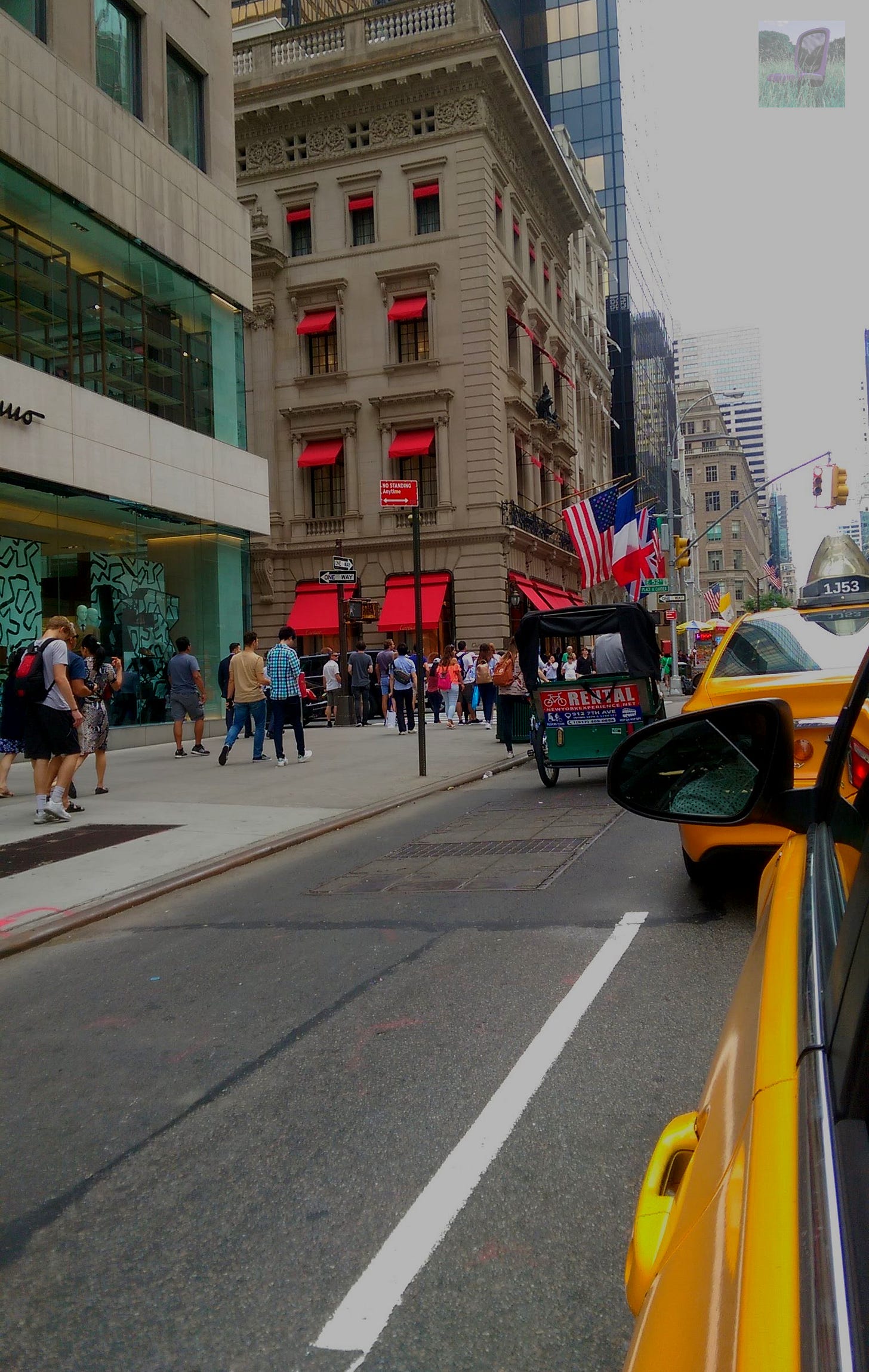 A view of NYC from the back passenger window of the famous yellow taxi.