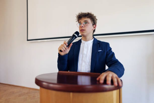 teenage boy giving a speech on school assembly - student podium stock pictures, royalty-free photos & images