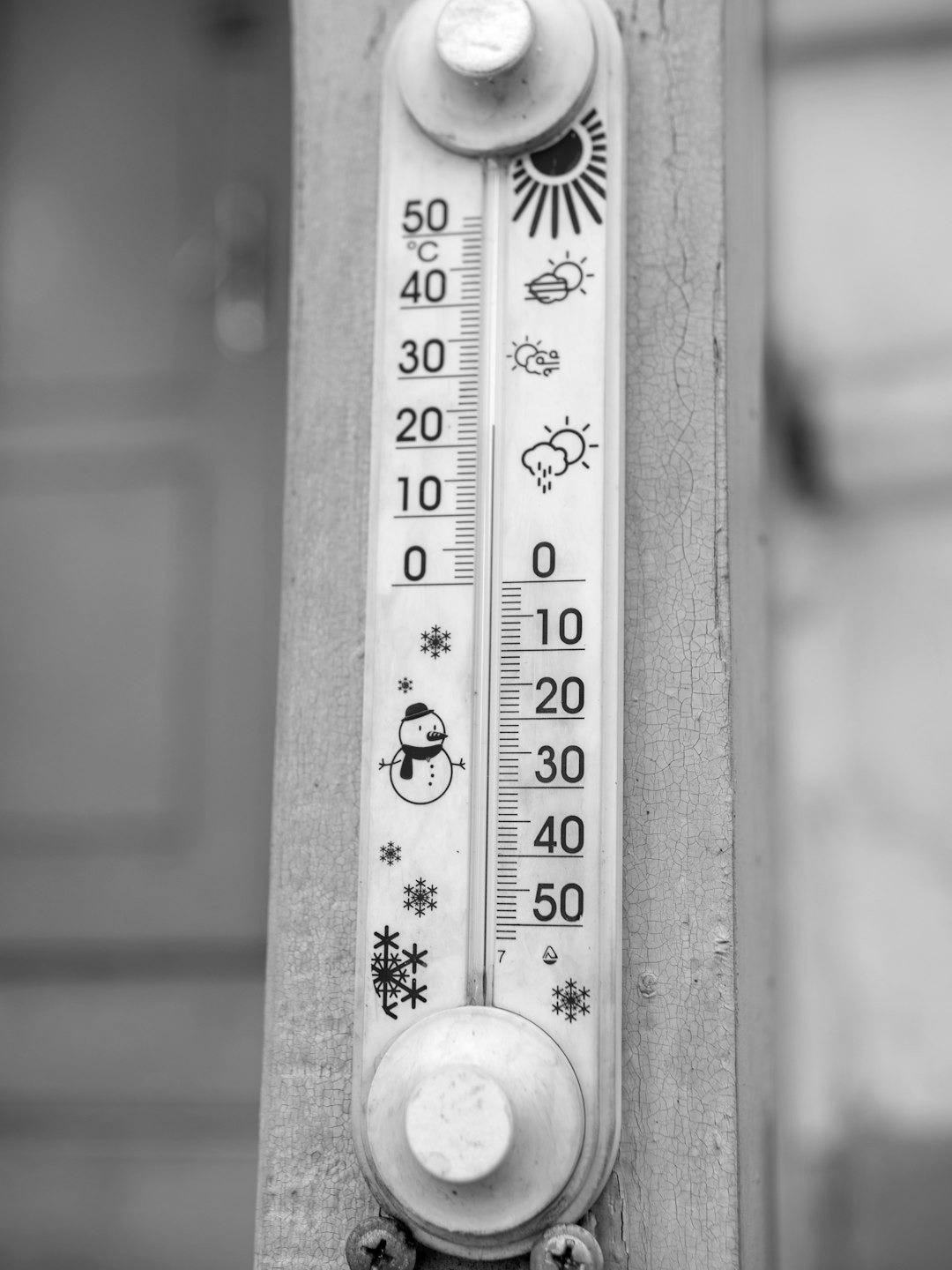 A thermometer shows a cold temperature with a snowman.