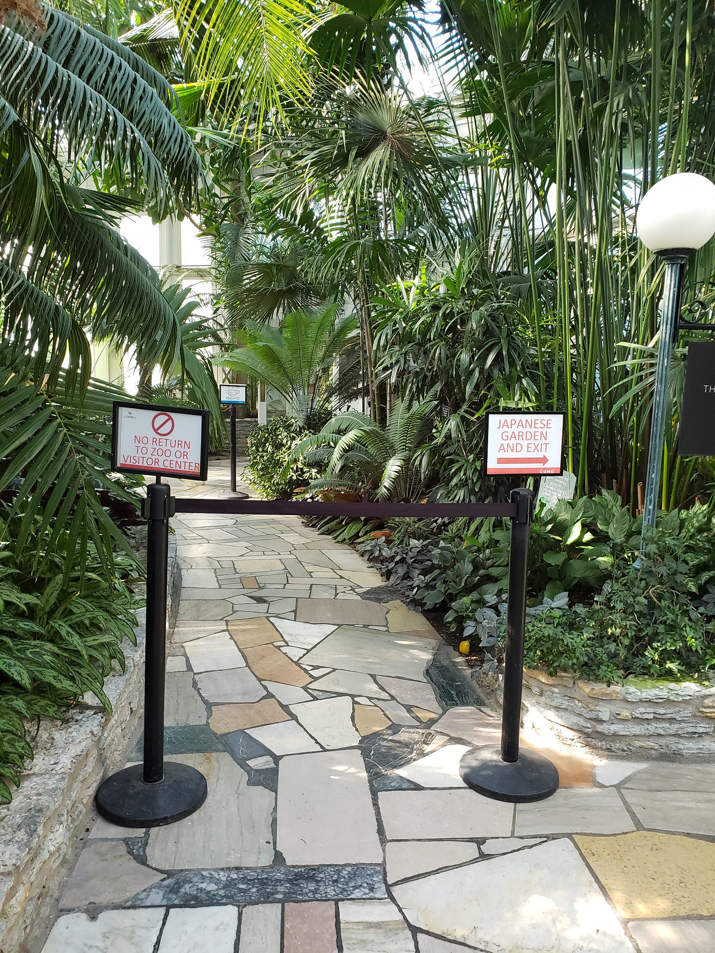 At the end of the path there are more signs indicating no return to zoo or visitor center and Japanese Garden and Exit are through the door to the right.