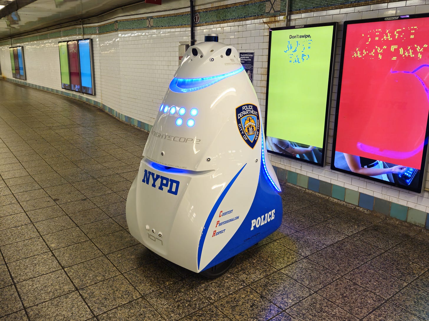 A photo of the Knightscope K5 autonomous robot in the Times Square subway station. A photo of the Knightscope K5 autonomous robot in the Times Square subway station.