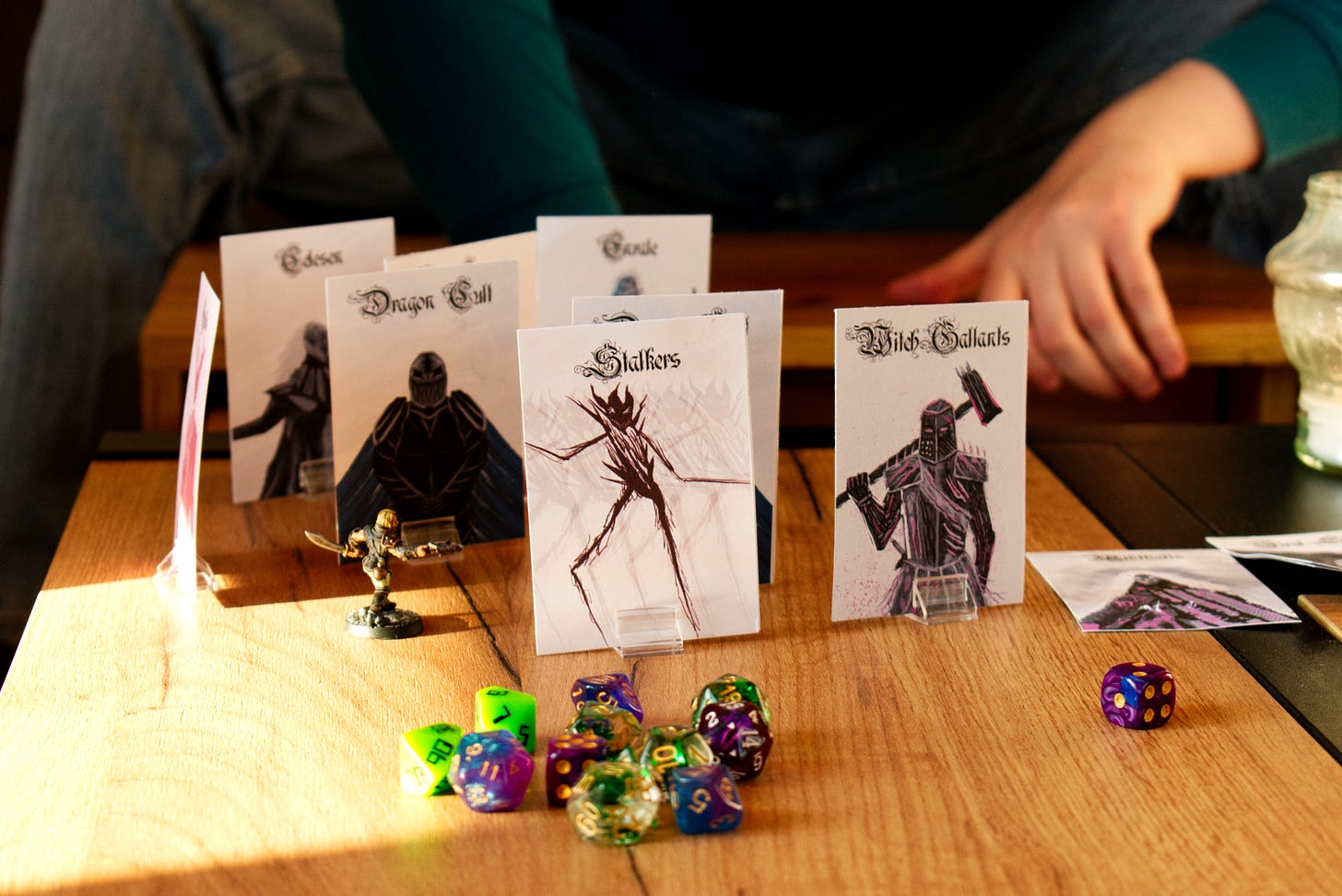 TTRPG standee minis, slips of paper with character art held up by plastic bases