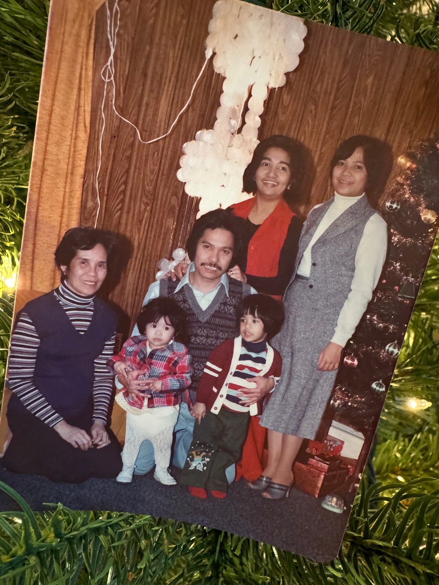 Filipino Family 4 adults, two children wearing winter clothes during holidays
