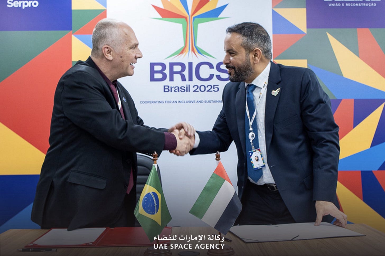 May be an image of ‎2 people, dais and ‎text that says "‎Serpro UWIAGERECONSTRUÇÃO UNIAO RECONSTRUÇÃO BRICS Brasil rasil2025 2025 .OИBATИErOEe.ИT FOR AN INCLUSIVE AND SUSTAINA COOPERATING للفضاء الإمارات كالة_االإمارات الا وكالة كالة UAE SPACE AGENCY‎"‎‎