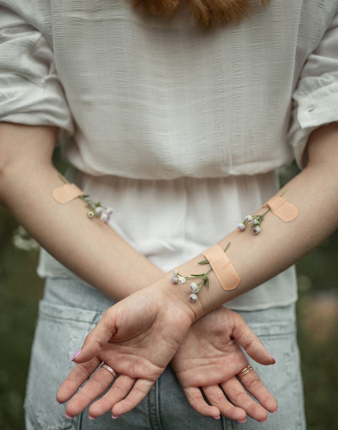 person with her arms crossed on her back