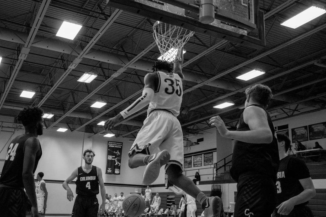 grayscale photo of basketball players playing basketball grayscale photo of basketball players playing basketball