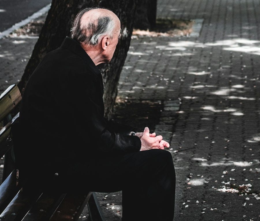 woman in black jacket standing beside tree during daytime