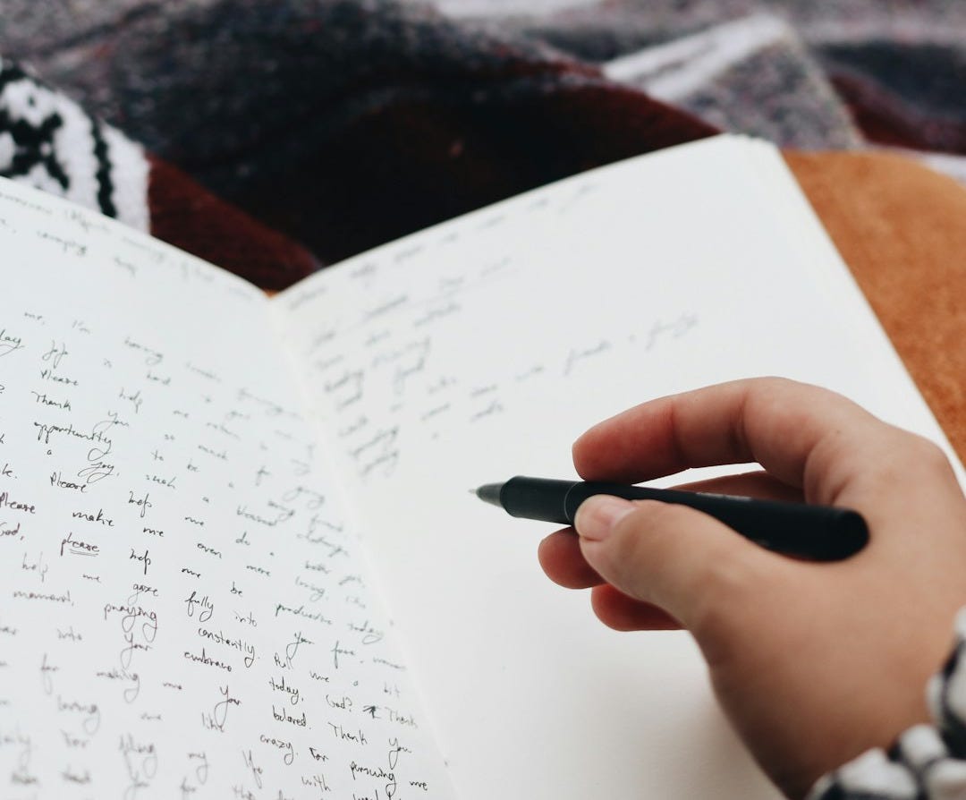 person writing on white paper